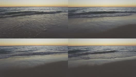 日落之后，海面平静，小波浪冲刷着沙滩高清在线视频素材下载