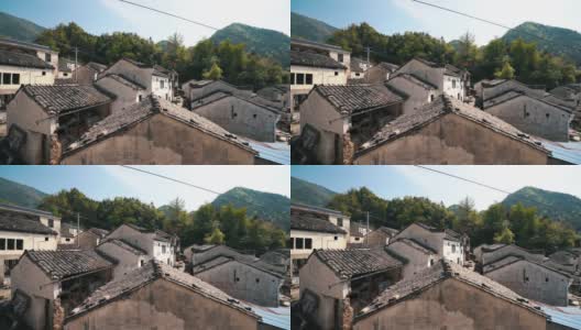 中国老安徽风格的砖瓦屋顶房屋，以山为背景的春天高清在线视频素材下载