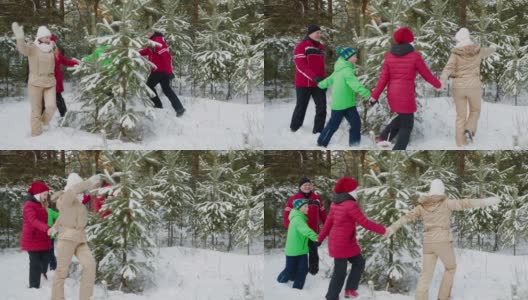 欢乐的家庭围绕着冷杉在冬天的森林里跳舞高清在线视频素材下载