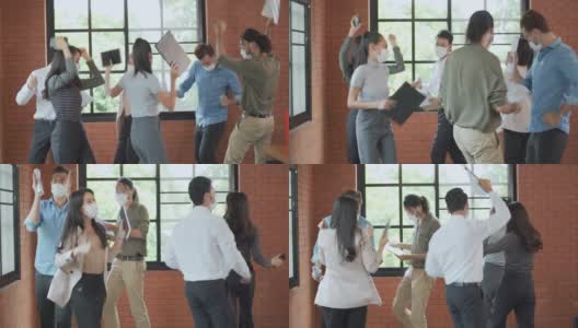 一群戴着口罩的工作人员在办公室一起跳舞、庆祝高清在线视频素材下载
