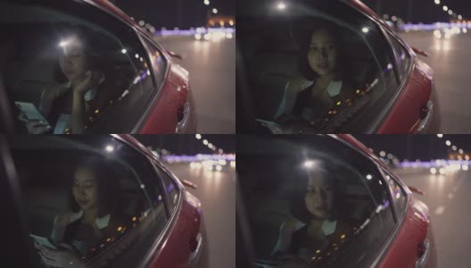 女人用电话在汽车里通过城市晚上回家高清在线视频素材下载