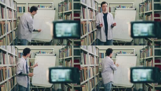 一名男老师正在图书馆上在线课，讲解公式高清在线视频素材下载
