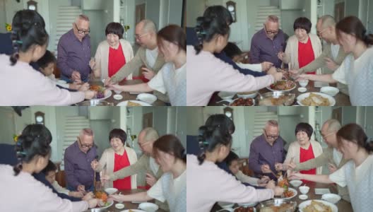 亚洲华人家庭用传统食物庆祝中国新年前夕，楼继伟在团圆饭上唱歌高清在线视频素材下载