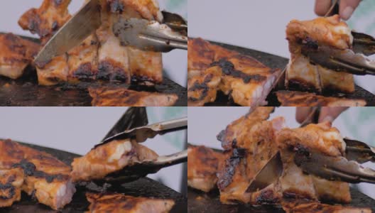 慢动作:厨师用刀在火盆上切出多汁的肉排高清在线视频素材下载