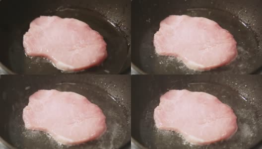 一块鲜肉在煎锅里炸着高清在线视频素材下载