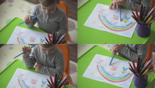 童年，艺术，教育，创意概念-真实的学前儿童未成年聪明的创意天才男孩2-4岁用彩色铅笔画画家庭的春天夏天，家里的彩虹高清在线视频素材下载