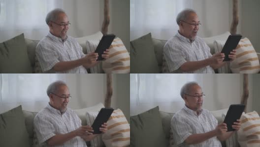 一个老人在家里用数码平板电脑打视频电话高清在线视频素材下载