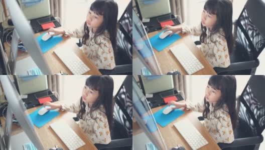 小女孩在家里的台式电脑上在线学习高清在线视频素材下载