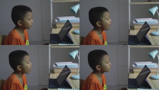 亚洲男孩在家里用平板电脑看媒体。高清在线视频素材下载