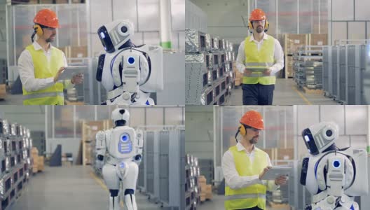 一个工人在仓库和一个机器人说话。高清在线视频素材下载