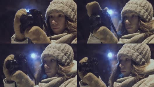 女孩摄影师拍摄户外雪冬夜灯光公园高清在线视频素材下载
