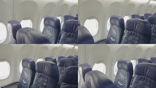 商用飞机机舱内部，乘客座位为蓝色。高清在线视频素材下载