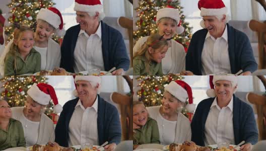 快乐的爷爷奶奶和孙女们一起享用圣诞晚餐高清在线视频素材下载