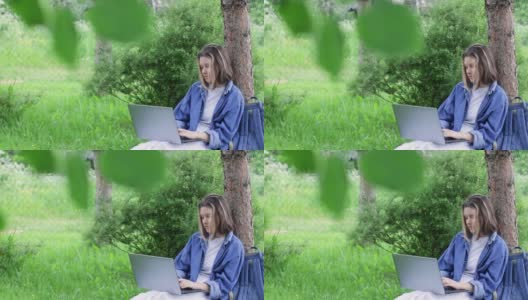 美丽的少女在后院附近的树上上课。在线学习和远程教育的概念高清在线视频素材下载