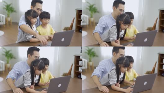 亚洲孩子在家和父亲一起上网络课程。高清在线视频素材下载