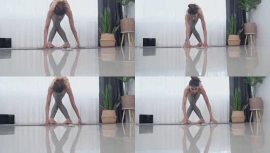 亚洲妇女在运动服做运动训练瑜伽垫在家里。高清在线视频素材下载