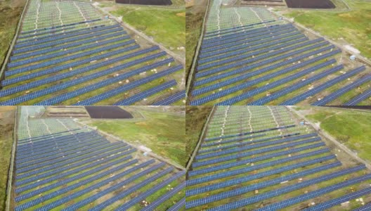 绿地上正在建设的太阳能发电厂鸟瞰图。组装用于清洁生态能源生产的电板高清在线视频素材下载