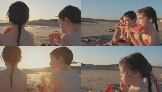 三个孩子在海滩上吃西瓜高清在线视频素材下载