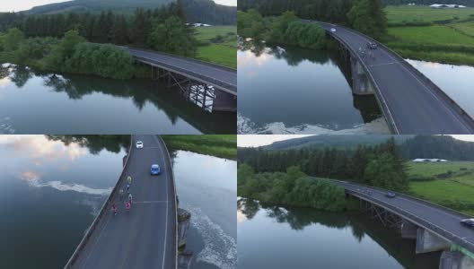 一群骑自行车的人正在过桥的鸟瞰图。高清在线视频素材下载
