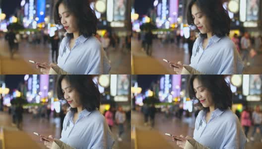 一个年轻漂亮的亚洲女人在晚上使用智能手机的慢镜头高清在线视频素材下载