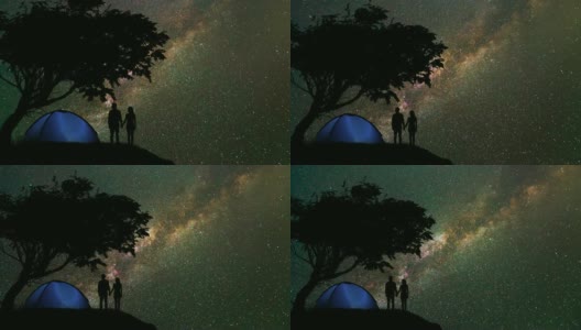 这对情侣站在一个露营帐篷附近，背景是星空。时间流逝高清在线视频素材下载