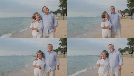 年老的亚洲夫妇走在海滩上一起笑。有生活方式、情感和退休观念的人。高清在线视频素材下载