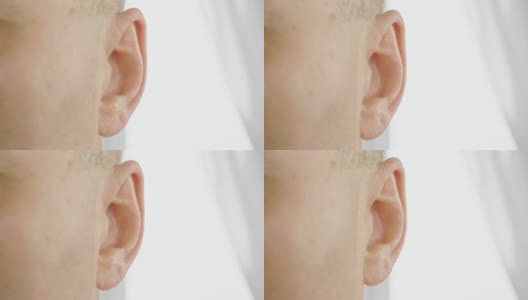 成年男性的耳朵靠近。男人在动他的耳朵。耳鼻喉科和听力健康高清在线视频素材下载