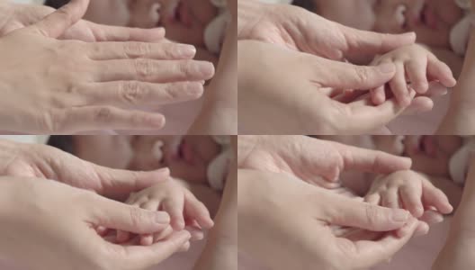 这是母亲在家里用指甲钳剪孩子的指甲的特写。婴儿身体护理概念。特写镜头前视图高清在线视频素材下载