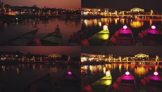 越南广南会安——2020年3月8日:在Thu Bon河上，游船带着漂浮的灯笼。人们在会安老城的桥上，联合国教科文组织世界遗产。高清在线视频素材下载