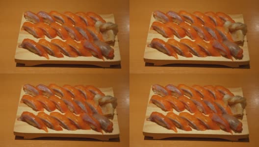 一套大马哈鱼手握寿司，木制托盘，在日本餐厅供应高清在线视频素材下载