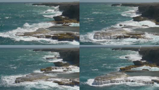 慢镜头:巨浪冲击着岩石峭壁，溅起狂乱的水花高清在线视频素材下载