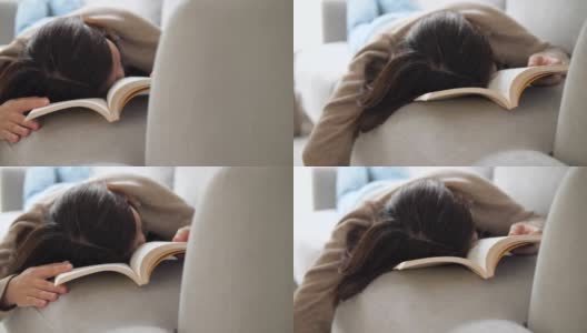 女人在假期在家客厅看书后睡觉和休息高清在线视频素材下载