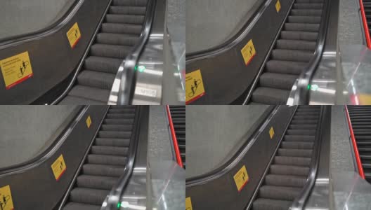 地铁车站内的自动扶梯及楼梯。查找通往地下和地铁出口的空电动扶梯和楼梯的录像。高清在线视频素材下载