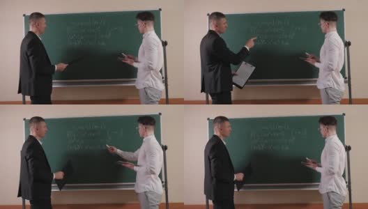 在数学教室里，一个年轻的老师在黑板附近和一个学生谈话。高清在线视频素材下载