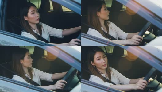 一个亚洲女人看着侧镜，试图把车停在停车场高清在线视频素材下载