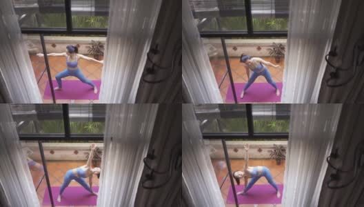 早上，一位亚洲华人中年妇女在她家的前院练习瑜伽高清在线视频素材下载