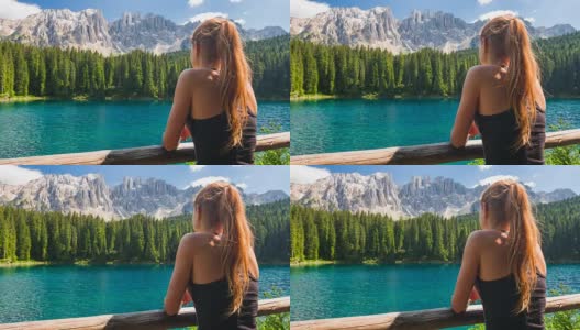 女游客在多洛米特山的湖看惊人的景色高清在线视频素材下载