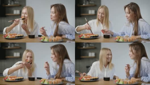 两个漂亮的女孩在家吃日本菜。卷在盘子里是不一样的，很好吃高清在线视频素材下载