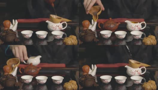 茶道。师傅将茶倒在白色杯子上高清在线视频素材下载