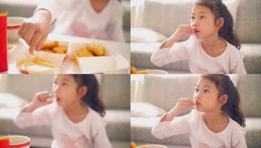 小女孩在家客厅吃垃圾食品高清在线视频素材下载
