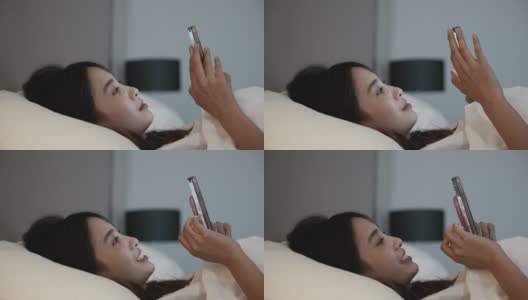 Scene of young asian woman enjoy using smartphone on the bed高清在线视频素材下载
