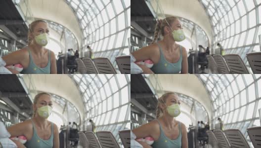 一名在机场戴着医用防护口罩的白人妇女在飞机的背景下。冠状病毒sars-cov-2 covid-19。高清在线视频素材下载