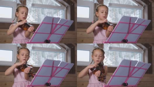 创意儿童在家里用小提琴演奏歌曲高清在线视频素材下载