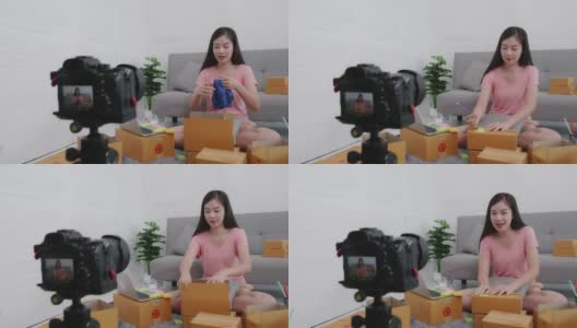 亚洲女性小企业主利用现场摄像机在网上卖衣服高清在线视频素材下载