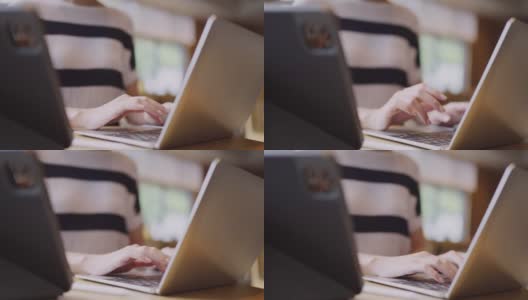 靠近年轻的亚洲女性用户工人的女性手在笔记本电脑上打字，笔记本电脑键盘坐在咖啡馆的桌子上工作，与笔记本电脑软件应用程序技术概念高清在线视频素材下载