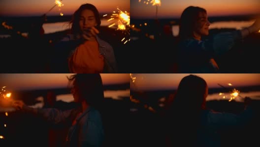 夏日日落时，快乐的年轻女子在小山上玩烟火高清在线视频素材下载