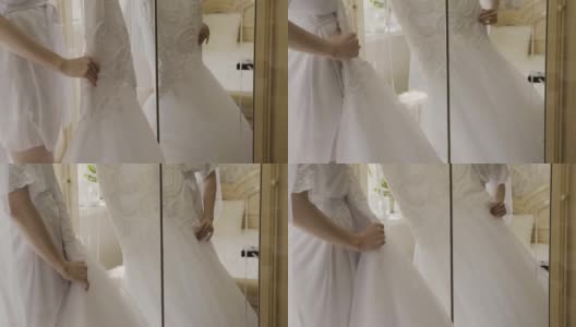 旅馆房间里衣架上的蓬松婚纱。婚礼的早晨高清在线视频素材下载