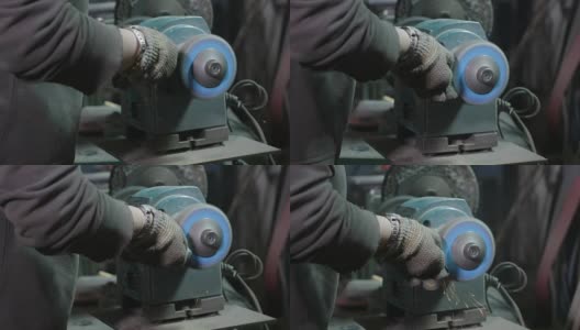 女铁匠在她的车间里用研磨机抛光金属高清在线视频素材下载