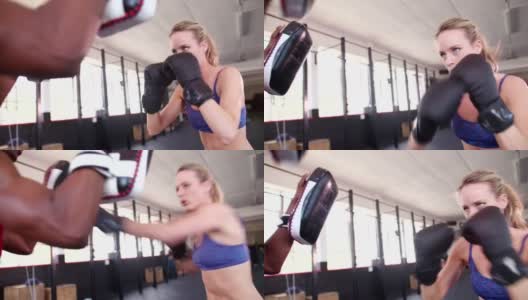 拳击手女孩和她的拳击搭档在健身房打架高清在线视频素材下载