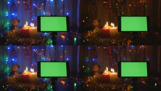 新年的背景，在前景有一个绿色屏幕的智能手机。一个很好的机会添加您的问候视频。高清在线视频素材下载